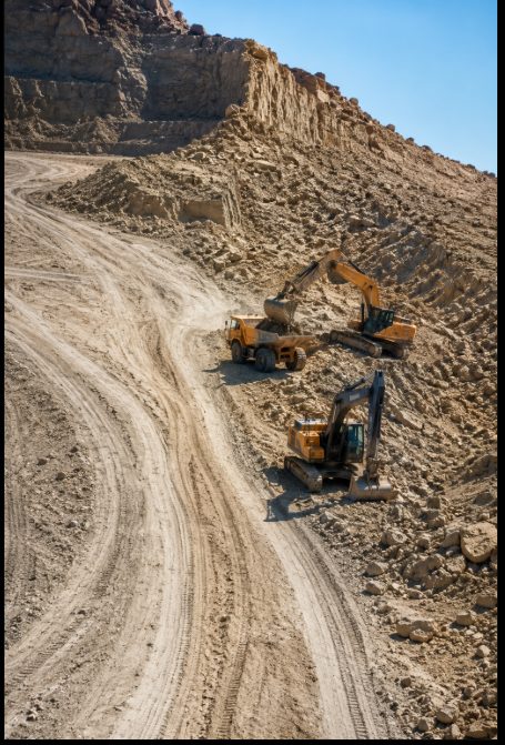Aerial view of trucks and excavators working the Kyzylkum Desert quarry